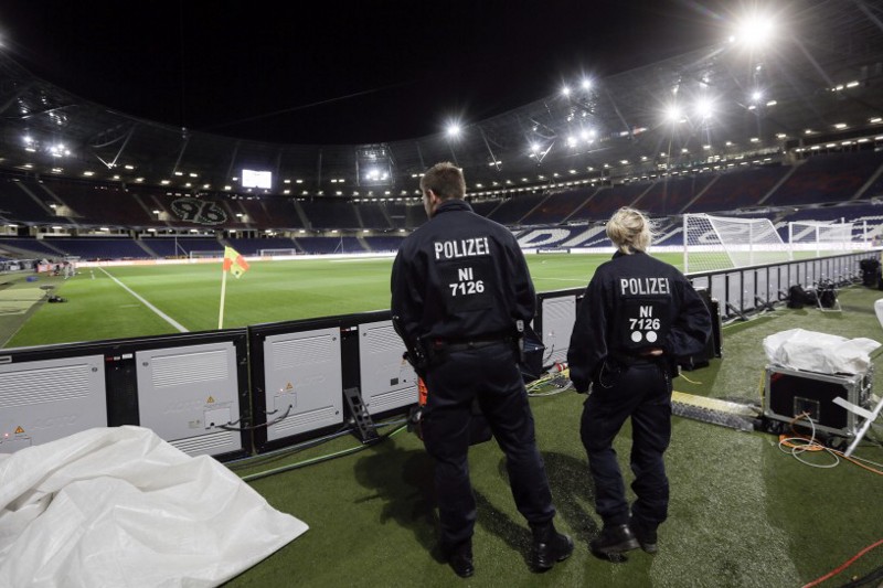 Two police officers stand in the stadium in Hannover, Germany, early Wednesday, Nov. 18, 2015, after friendly soccer game between Germany and the Netherlands was canceled 90 minutes before kickoff on Tuesday due to the suspected threat of a bomb at the stadium. (AP Photo/Markus Schreiber) CREDIT: Markus Schreiber, AP