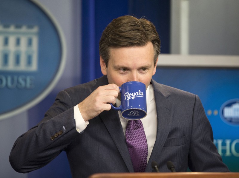 White House Press secretary Josh Earnest takes a drink from his Kansas City Royals’ coffee cup before speaking to the media during the daily briefing in the Brady Press Briefing Room of the White House, Thursday, Oct. 29, 2015. CREDIT: AP PHOTO/PABLO MARTINEZ MONSIVAIS