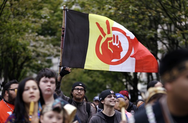 An American Indian Movement flag is flown during a march for Indigenous Peoples Day, Monday, Oct. 12, 2015, in Seattle. The Seattle City Council approved a resolution to designate the second Monday in October Indigenous Peoples Day to celebrate the culture of Native Americans. CREDIT: AP Photo/Elaine Thompson