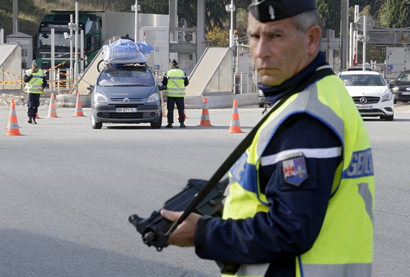 French police check vehicles at the France Italy border in La Turbie, southeastern France, Saturday, Nov. 14, 2015. French President Francois Hollande said more than 120 people died Friday night in shootings at Paris cafes, suicide bombings near France’s national stadium and a hostage-taking slaughter inside a concert hall. (AP Photo/Lionel Cironneau) CREDIT: AP PHOTO/LIONEL CIRONNEAU