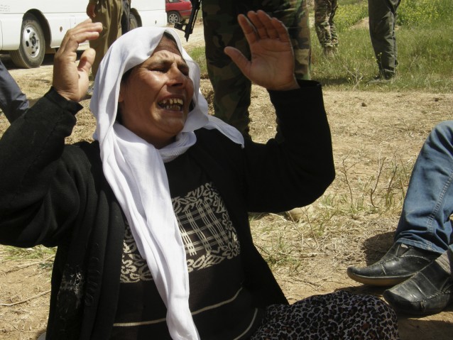 A Yazidi woman released by Islamic State group militants cries for her other family members still captured by the IS group upon her arrival in Kirkuk, 180 miles north of Baghdad, Iraq, Wednesday, April 8, 2015. CREDIT: AP Photo