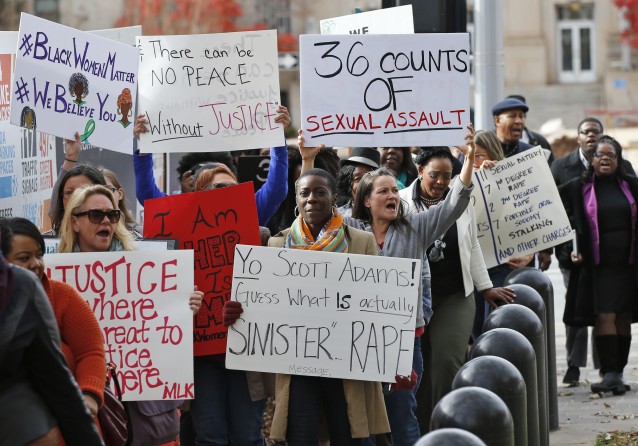 Protestors carry signs outside the courthouse as the jury deliberates in the trial of Daniel Holtzclaw CREDIT: AP Photo/Sue Ogrocki
