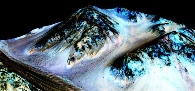 This photo, provided by NASA, was taken by an instrument aboard the agency’s MRO and shows the streaks that scientists now believe were caused by flowing streams of salty water. Water on Mars: Someone alert The Doctor. CREDIT: NASA/JPL/University of Arizona via AP
