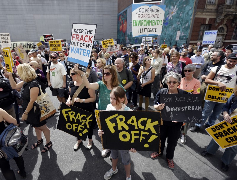 Protestors opposed to hydraulic fracturing, demonstrate outside a Marcellus Shale industry conference, Thursday, Sept. 20, 2012. A lawsuit filed by the Pennsylvania attorney general accuses Chesapeake Energy of underpaying thousands of rural landowners (AP Photo/Matt Rourke)