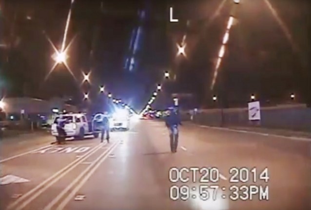 In this Oct. 20, 2014 frame from dash-cam video provided by the Chicago Police Department, Laquan McDonald, right, walks down the street moments before being shot by officer Jason Van Dyke in Chicago. CREDIT: Chicago Police Department via AP
