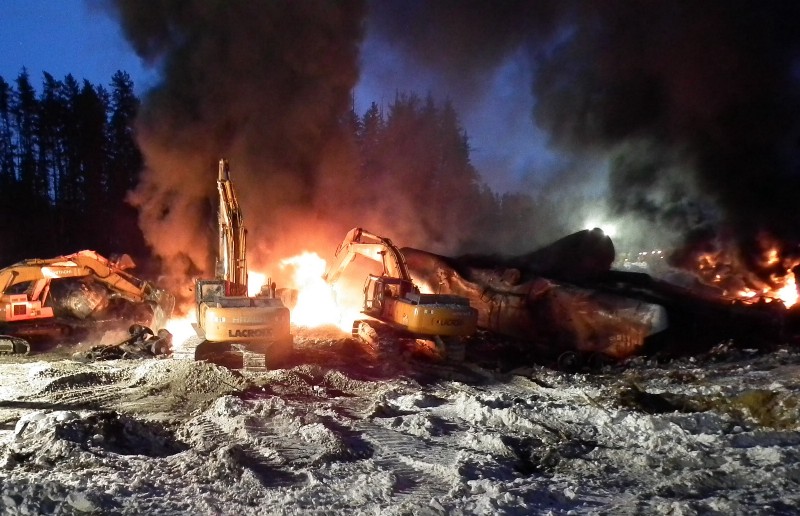 In this Feb. 16, 2015 photo, provided by the Transportation Safety Board of Canada, workers fight a fire after a crude oil train derailment south of south of Timmins, Ontario. CREDIT: AP PHOTO/TRANSPORTATION SAFETY BOARD OF CANADA