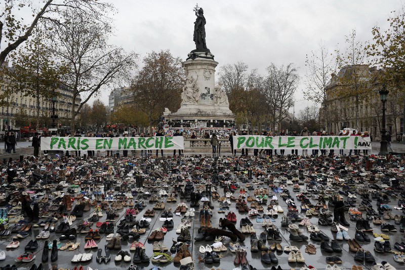 Hundreds of pairs of shoes are displayed at the place de la Republique, in Paris, as part of a symbolic and peaceful rally before the climate talks. CREDIT: AP PHOTO/LAURENT CIPRIANI