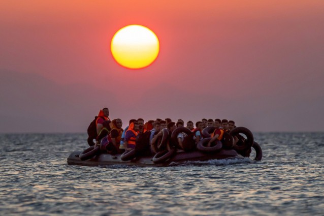 Migrants on a dinghy arrives at the southeastern island of Kos, Greece, after crossing from Turkey CREDIT: AP Photo/Alexander Zemlianichenko, File