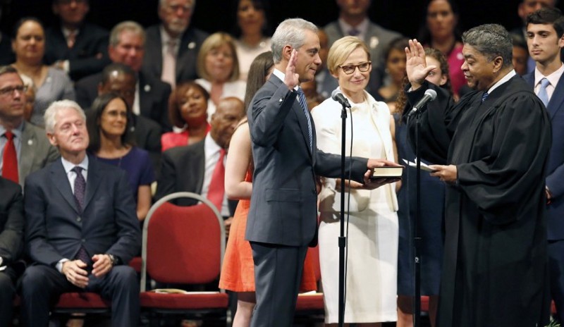Chicago mayor Rahm Emanuel, center, takes the oath of office for a second term. CREDIT: Charles Rex Arbogast, AP