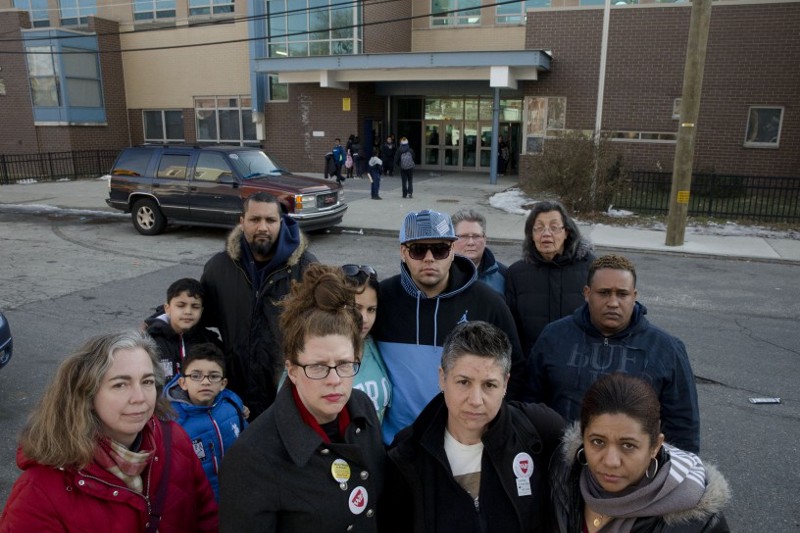 Feltonville School of Arts and Sciences teachers Kelley Collings, center left, and Amy Roat, center right, pose for a portrait with parents, teachers and students Wednesday, Feb. 4, 2015, in Philadelphia. CREDIT: Matt Rourke, AP