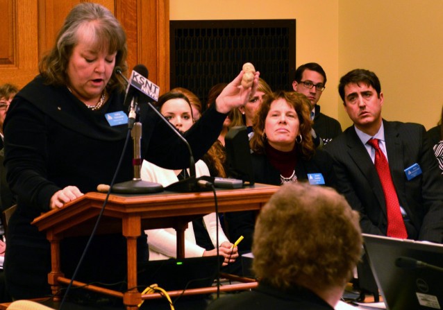 Kathy Ostrowski, legislative director for the anti-abortion group Kansans for Life, holds up a model of fetus during a Kansas Senate committee hearing, Monday, Feb. 2, 2015 CREDIT: AP Photo, Nicholas Clayton