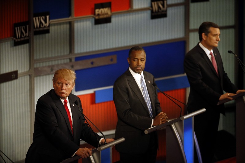 Donald Trump, left, Ben Carson and Ted Cruz listen during the Republican presidential debate at the Milwaukee Theatre, Wednesday, Nov. 11, 2015, in Milwaukee. CREDIT: AP PHOTO/MORRY GASH
