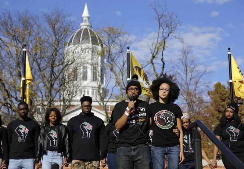 Graduate student Jonathan Butler, center, addresses a crowd following the announcement that University of Missouri System President Tim Wolfe would resign. CREDIT: Jeff Roberson, AP