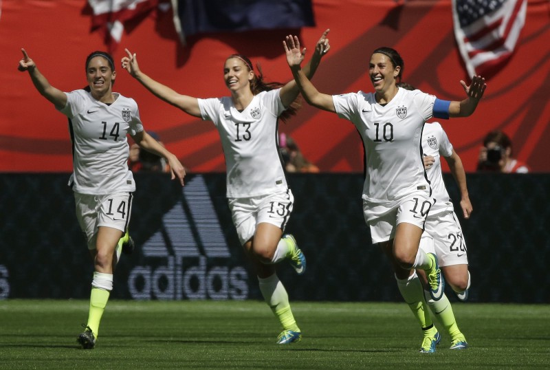 From left, United States’ Morgan Brian, Alex Morgan, and Carli Lloyd celebrate after Lloyd scored her second goal of the match against Japan during the first half of the FIFA Women’s World Cup. Sunday, July 5, 2015. CREDIT: ELAINE THOMPSON, AP