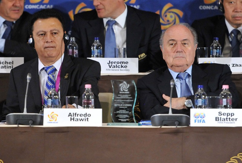 FILE — In this picture taken May 23, 2012 in Budapest, Hungary, Alfredo Hawit of Honduras, left, interim Head of CONCACAF and FIFA President Joseph Blatter sit next to each other. CREDIT: SZILARD KOSZTICSAK, MTI (AP/FILE)