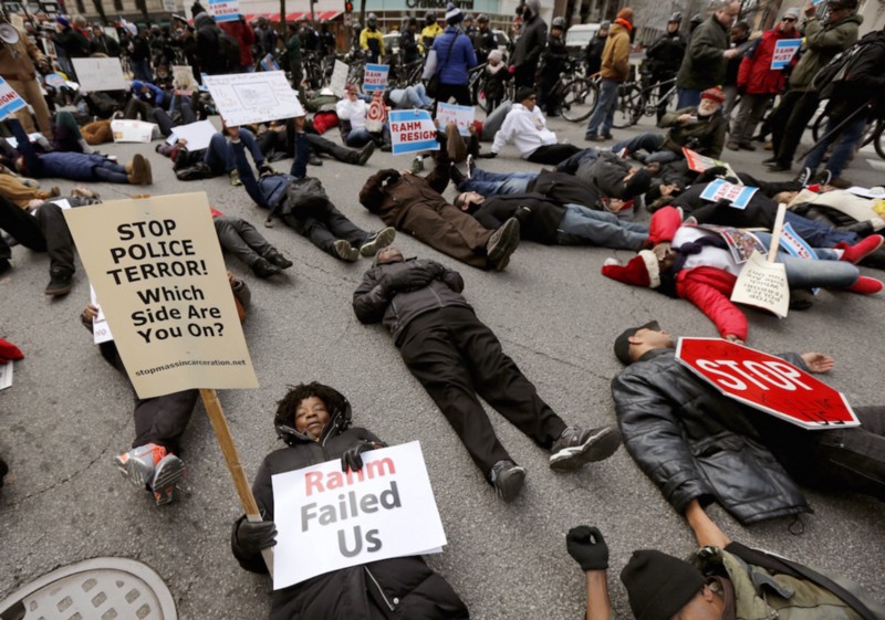 Protesters block an intersection on Chicago’s Magnificent Mile, calling for the resignation of Mayor Rahm Emanuel, Thursday, Dec. 24, 2015, in Chicago. The Christmas Eve protest is the latest in a series of demonstrations in the city since the release last month of police video showing a white officer shooting a black teenager 16 times. (AP Photo/Charles Rex Arbogast) CREDIT: ASSOCIATED PRESS