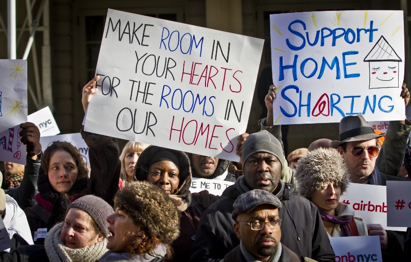 Supporters of Airbnb hold a rally outside City Hall to protest a hearing with New York City lawmakers that aimed to scrutinize the service in early 2015. CREDIT: AP PHOTO/BEBETO MATTHEWS