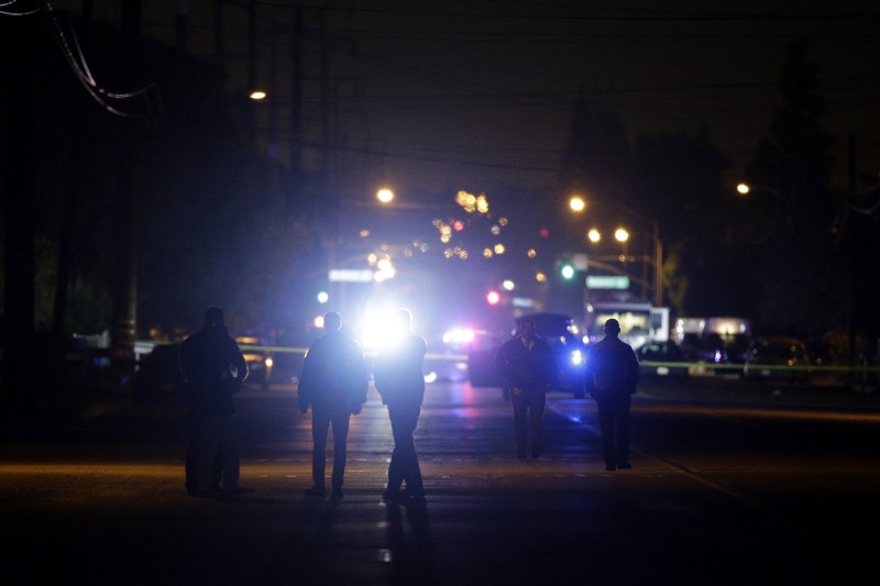 Authorities investigate the scene following a shootout Wednesday, Dec. 2, 2015, in San Bernardino, Calif. Multiple attackers opened fire on a banquet at a social services center for the disabled in San Bernardino on Wednesday, killing multiple people and sending police on a manhunt for suspects. (AP Photo/Jae C. Hong) CREDIT: AP PHOTO/JAE C. HONG