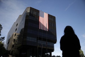 Emily Petrus, a worker for San Bernardino County, pauses to look at a large flag hanging on San Bernardino City Hall on Monday, Dec. 7, 2015 in San Bernardino, Calif. CREDIT: AP Photo/Jae C. Hong