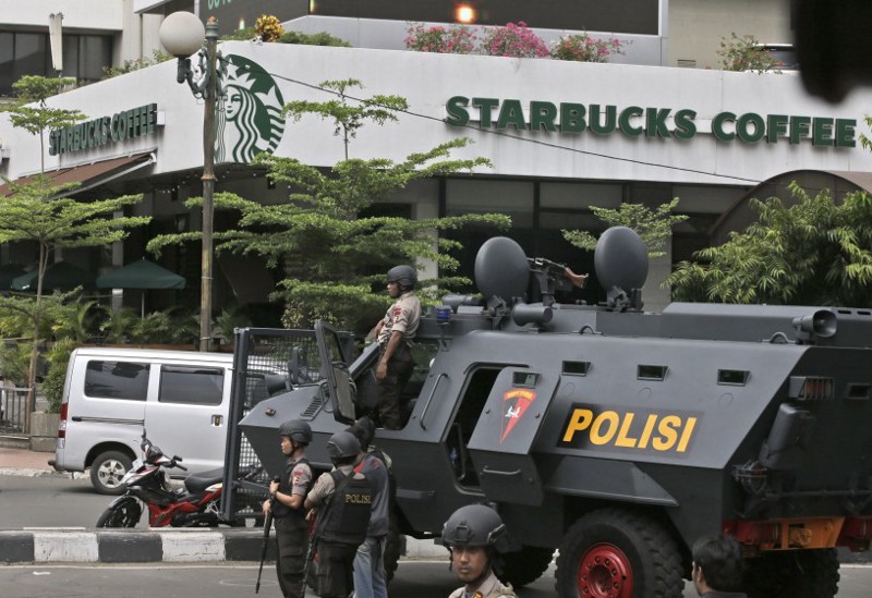 A police armored vehicle is parked outside a Starbucks cafe after an explosion in Jakarta, Indonesia Thursday, Jan. 14, 2016. Attackers set off explosions at a Starbucks cafe in a bustling shopping area in Indonesia’s capital and waged gunbattles with police Thursday, leaving bodies in the streets as office workers watched in terror from high-rise buildings. CREDIT: AP Photo/Achmad Ibrahim