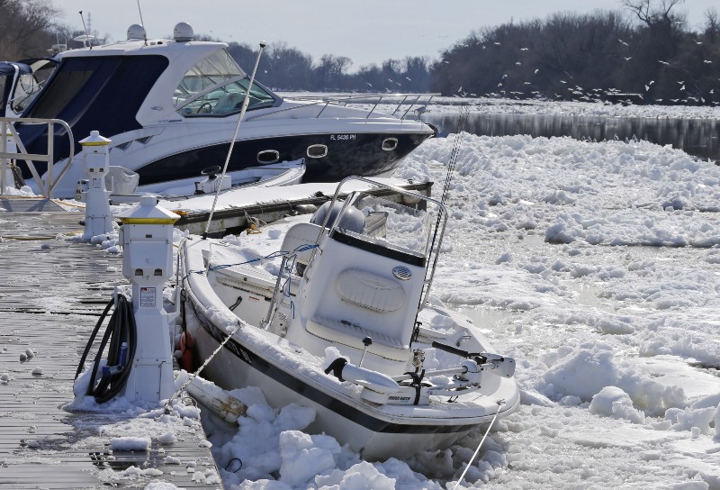 Boats are trapped in ice that clogs the James river as it flows past downtown Richmond, Va., Monday, Jan. 25, 2016. Area residents and businesses are continuing to dig out from from the massive snowstorm over the weekend. CREDIT: AP PHOTO/STEVE HELBER