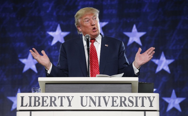Republican Presidential candidate Donald Trump gestures during a speech at Liberty University CREDIT: AP PHOTO/STEVE HELBER