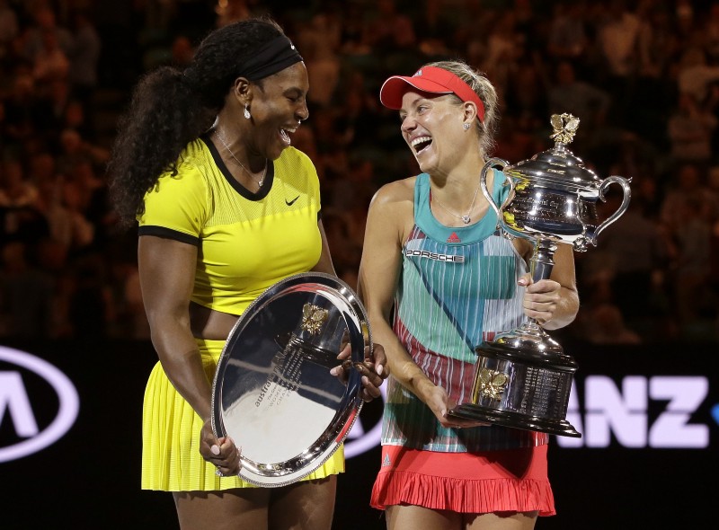 Angelique Kerber holds the trophy with runner-up Serena Williams after winning their women’s singles final at the Australian Open tennis championships in Melbourne, Australia, Saturday, Jan. 30, 2016. CREDIT: AARON FAVILA, AP