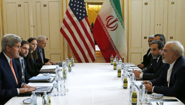 U.S. Secretary of State John Kerry, left, meets with Iranian Foreign Minister Mohammad Javad Zarif, right, in Vienna, Austria, Saturday, Jan. 16, 2016, on what is expected to be “implementation day,” the day the International Atomic Energy Agency (IAEA) verifies that Iran has met all conditions under the nuclear deal. CREDIT: Kevin Lamarque/Pool Photo via AP