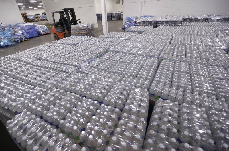 A forklift driver moves a pallet of water in a warehouse Tuesday, Jan. 19, 2016, in Flint, Mich. Area residents dealing with contaminated drinking water in Flint will be the recipients of the water, which they can pick up at fire stations throughout the city. CREDIT: AP PHOTO/CARLOS OSORIO