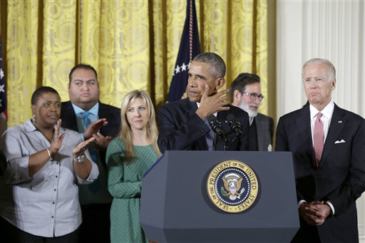 President Barack Obama, joined by Vice President Joe Biden and gun violence victims, wipes tears from his cheek as speaks in the East Room of the White House in Washington, Tuesday, Jan. 5, 2016, about steps his administration is taking to reduce gun violence. Also on stage are stakeholders, and individuals whose lives have been impacted by the gun violence. CREDIT: AP PHOTO/CAROLYN KASTER