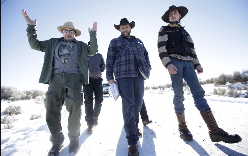 Burns resident Steve Atkins, left, talks with Ammon Bundy, center, one of the sons of Nevada rancher Cliven Bundy, following a news conference at Malheur National Wildlife Refuge Friday, Jan. 8, 2016. CREDIT: AP PHOTO/RICK BOWMER