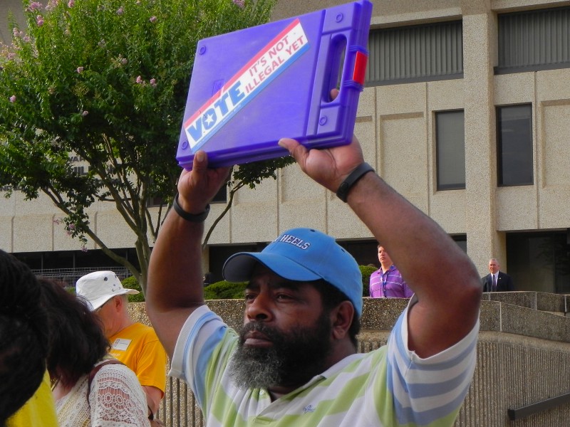 A voter in Winston-Salem, NC protests the new voter ID law. CREDIT: ALICE OLLSTEIN