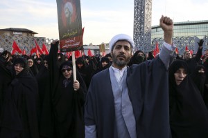 A Muslim cleric chants slogans alongside women in a rally to protest the execution by Saudi Arabia last week of Sheikh Nimr al-Nimr, a prominent opposition Saudi Shiite cleric, in Tehran, Iran, Monday, Jan. 4, 2016. CREDIT: AP Photo/Vahid Salemi
