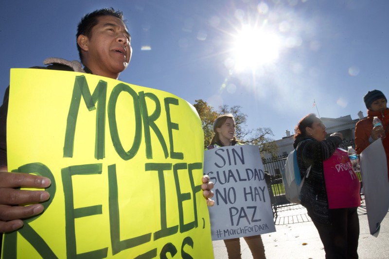 Alejandro Santiago, left, originally from Guatemala and now lives in Centreville, Va., rallies for immigration reform after marching from Arlington, Va., to the White House in Washington, Friday, Nov. 20, 2015, on the one-year anniversary of President Obama’s announcement concerning the Deferred Action for Childhood Arrivals, (DAPA). (AP Photo/Jacquelyn Martin) CREDIT: AP PHOTO/JACQUELYN MARTIN