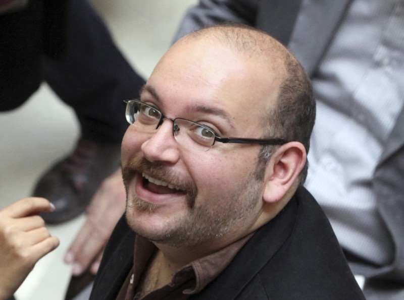 Jason Rezaian, an Iranian-American correspondent for the Washington Post, smiles as he attends a presidential campaign of President Hassan Rouhani in Tehran, Iran on April 11, 2013. CREDIT: AP PHOTO/VAHID SALEMI