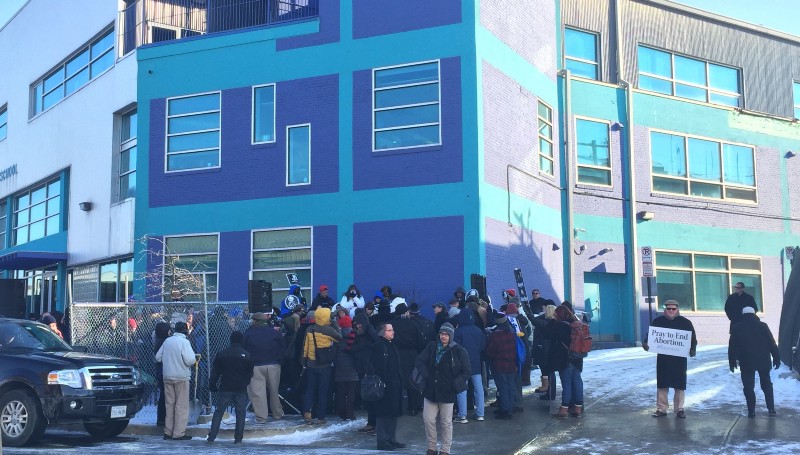 Anti-abortion protesters gather in front of Northeast D.C.’s Two Rivers Charter School to protest the nearby construction of a Planned Parenthood. CREDIT: ALEX ZIELINSKI