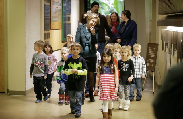 Republican presidential candidate Carly Fiorina walks with preschool students as she makes her way to speak at the Iowa Right to Life Presidential Forum, Wednesday, Jan. 20, 2016, in Des Moines, Iowa. CREDIT: AP Photo/Charlie Neibergall