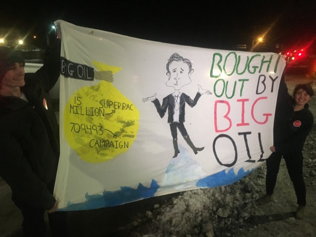 Volunteers with 350 Action dropped this banner during a Ted Cruz event in New Hampshire. CREDIT: Kira Lerner