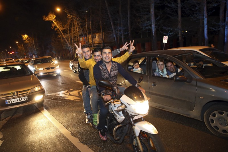 Iranians celebrate in northern Tehran, Iran, on Thursday, April 2, 2015, after Iran and the P5+1 (United States, United Kingdom, Russia, France, China, and Germany) reached an interim nuclear agreement. CREDIT: AP PHOTO/VAHID SALEMI