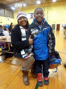 In a photo from Jan. 2, 2016, Sherri Miller and her son, Jameer, 7, a first-grader, are seen at Freeman Elementary School in Flint, Mich., where Jameer was getting his finger-prick blood sample tested for lead. CREDIT: AP Photo/Roger Schneider