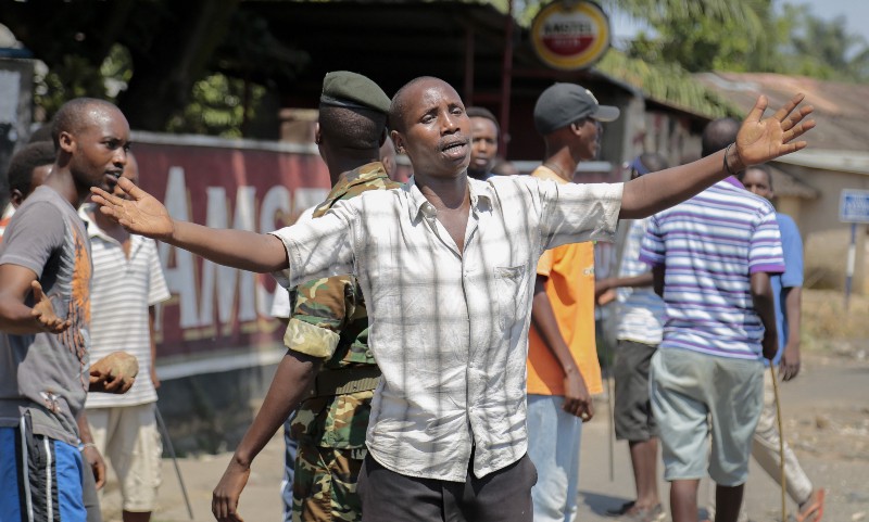 An opposition demonstrator gestures toward soldiers and tells them it is shameful to shoot on people who cannot defend themselves, in the Ngagara neighborhood of the capital Bujumbura, in Burundi Wednesday, June 3, 2015. CREDIT: AP PHOTO/GILDAS NGINGO