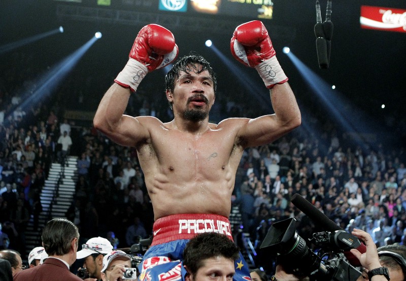 Manny Pacquiao, of the Philippines celebrates after his victory over Mexico’s Juan Manuel Marquez during a WBO welterweight title fight Saturday, Nov. 12, 2011, in Las Vegas. CREDIT: JAE C. HONG, AP