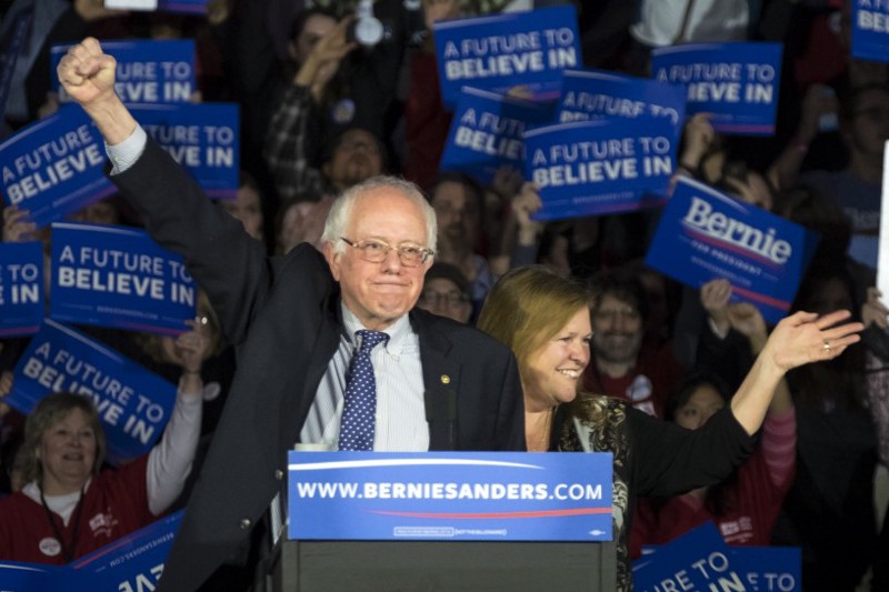 Democratic presidential candidate, Sen. Bernie Sanders, I-Vt, and his wave Jane acknowledge the crowd as he arrives for his caucus night rally in Des Moines, Iowa, Monday, Feb. 2, 2016.