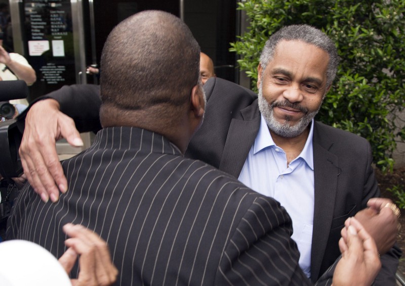 Lester Bailey, left, hugs friend Anthony Ray Hinton , right, after Hinton spent 30 years in prison CREDIT: AP PHOTO/HAL YEAGER