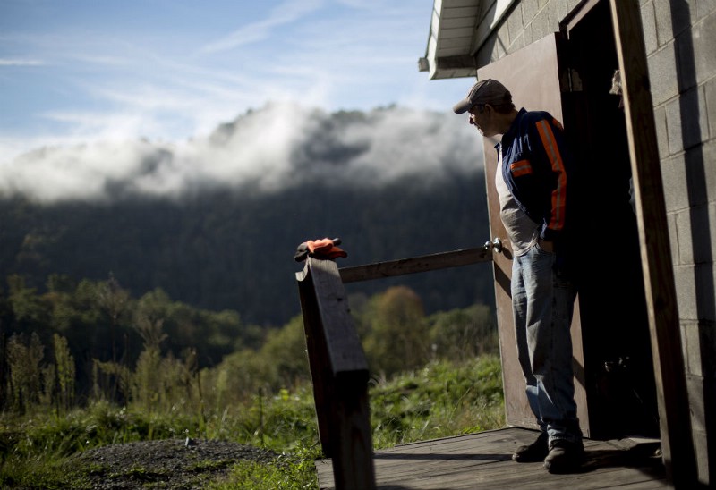 Mine foreman and electrician Randall Wright looks at mountains while working at the Sewell “R” coal mine Tuesday, Oct. 6, 2015, in Yukon, W.Va. Wright was making $35 an hour up until last year before he had to take a job at $15 an hour or face unemployment. CREDIT: AP PHOTO/DAVID GOLDMAN