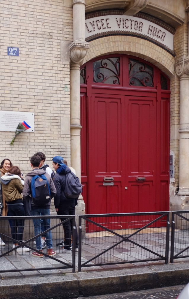 French high school students wait in front of Lycee Victor Hugo in Paris, Tuesday Feb, 2 2016. French high schools say students should be allowed to smoke on school grounds to stop them becoming terrorist targets when they gather for cigarette breaks outside. CREDIT: AP Photo/Jacques Brinon