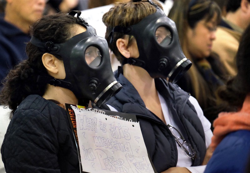 Protestors wearing gas masks, attend a hearing over a gas leak at the southern California Gas Company’s Aliso Canyon Storage Facility near the Porter Ranch section of Los Angeles. Scientists say a gas leak that forced thousands of people from their Los Angeles homes was the largest reported release of climate-changing methane in U.S. history. CREDIT: AP PHOTO/RICHARD VOGEL