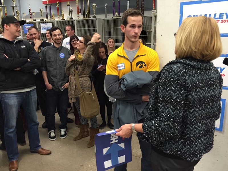 Martin O’Malley supporter Mike Mertell listens as a Hillary Clinton supporters tries to convince him to come to her side of the room. CREDIT: Emily Atkin