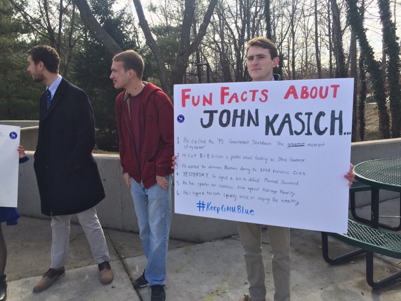 Joe Russell, 20, protests John Kasich outside of his event at George Mason University in Virginia on Monday. CREDIT: Emily Atkin