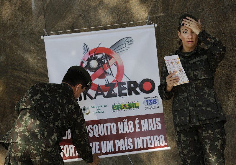 Army soldiers set up a sign that reads in Portuguese “A mosquito is not stronger than an entire country” at the Central station in Rio de Janeiro, Brazil, Saturday, Feb. 13, 2016. CREDIT: AP PHOTO, SILVIA IZQUIERDO